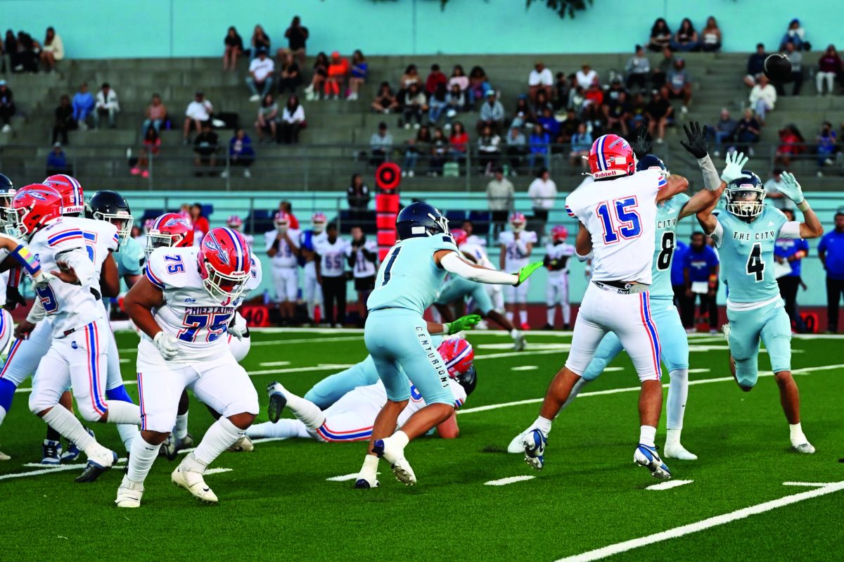 Seniors Xavier Quntanar, Emmanuel Wecheyi, and Matthew Bresko scramble for the ball.