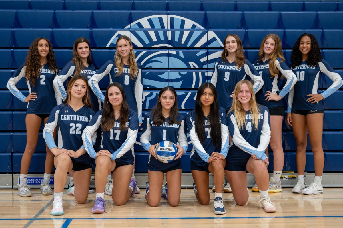 The UC High Varsity Girls Volleyball Team strikes a pose in the UC High gym.