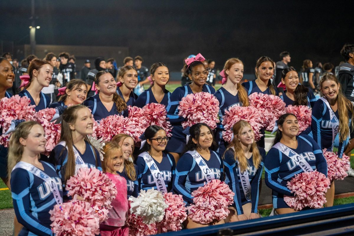 The UC Cheer Team seniors line up for a group photo for Senior Night Celebration.